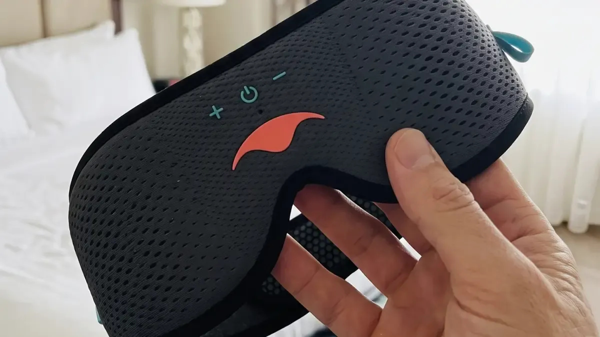 A hand holding the Manta SOUND Sleep Mask.