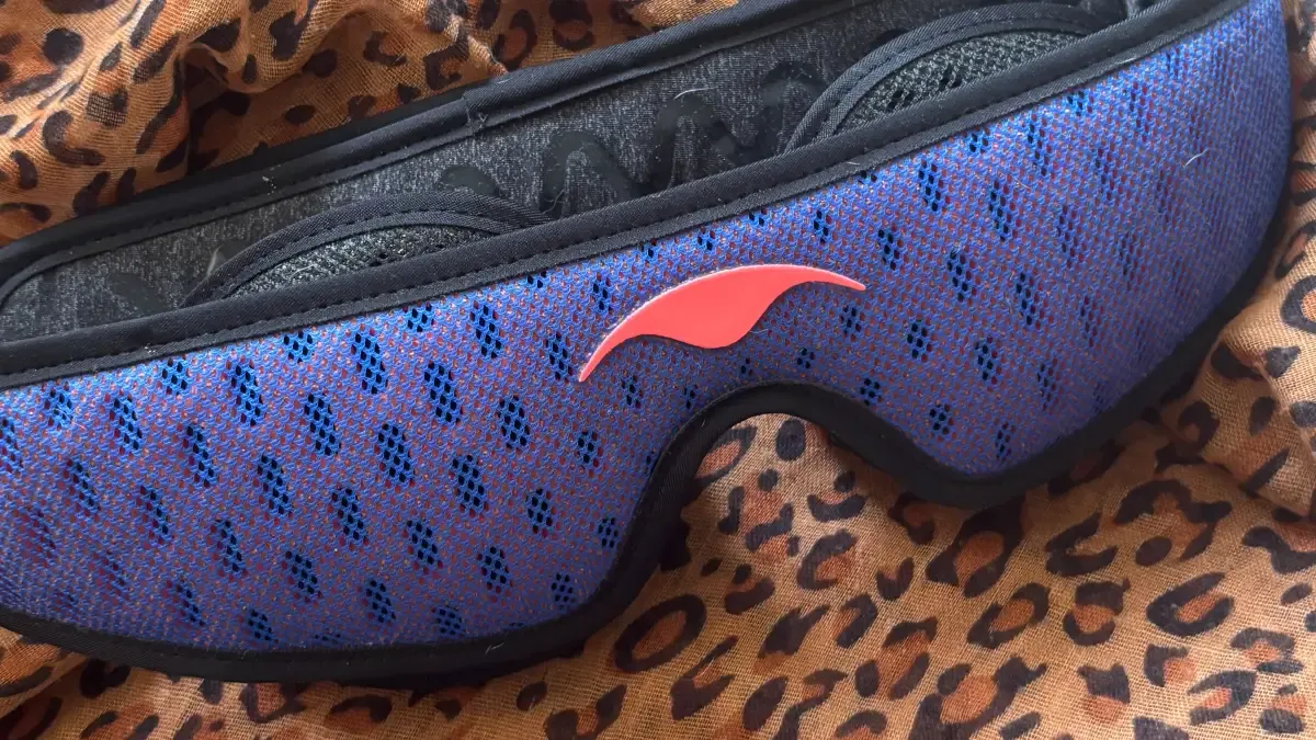 Manta PRO Sleep Mask lying on leopard print fabric.